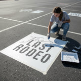 The Last Rodeo stenciled on pavement with matching parking space stencil.