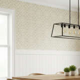 Modern interior with floral stenciled wallpaper, a chandelier, and a wooden table.