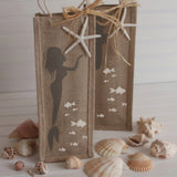 Mermaid Craft Stencil painted onto a mermaid theme wine bag with seashells surrounding it